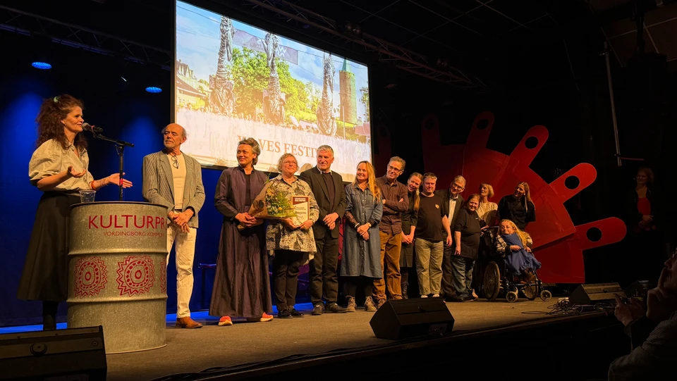 Billede af mennesker fra Waves Festival der får overrakt Publikumsprisen på en scene 